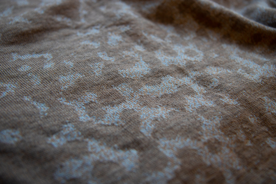 swatch of a marlet merino jumper. mottled animal print pattern in a soft brown and blue.