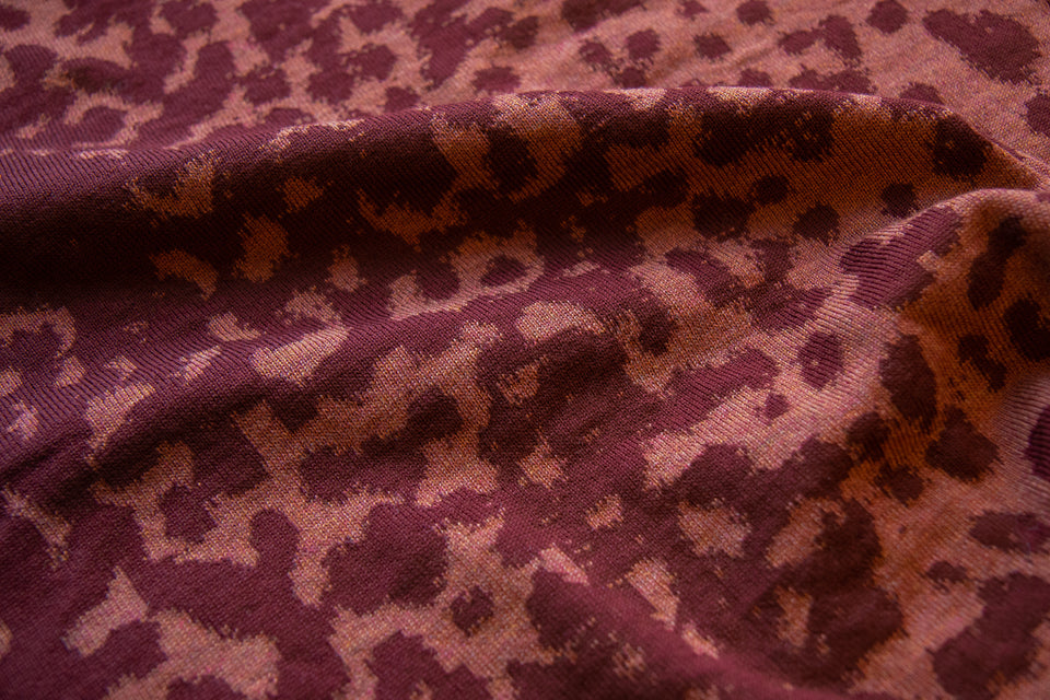 swatch of a marlet jumper, knitted in fine merino in an animal print. Dusty pink-coral and wine.