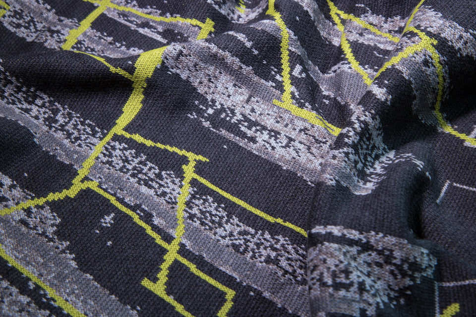 close up of knitted cape in greys with abstract linear pattern in fluoro yellow, by Nielanell, Shetland knitwear