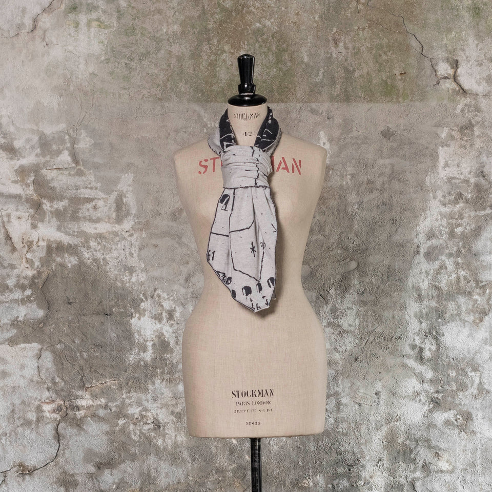 Knitted Byre cravat. Abstract, reversible graphic design in an asymmetric shape. Shown in Charcoal and stone white