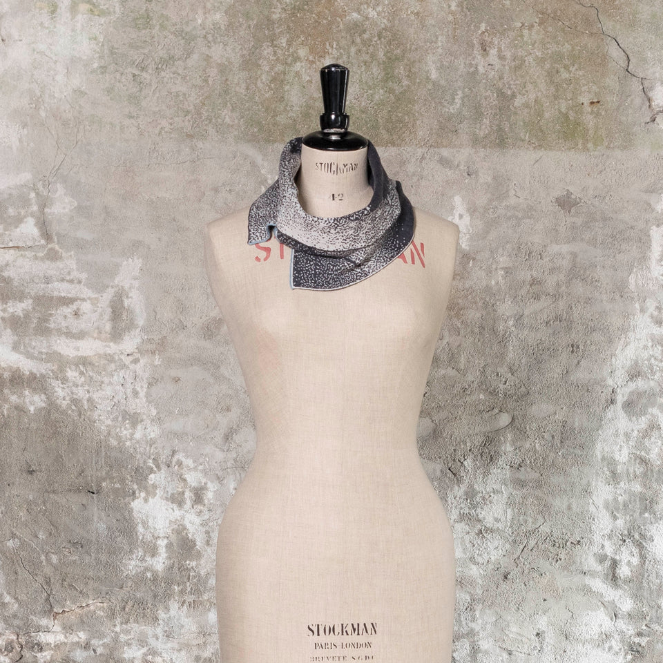 Knitted Byre cowl. Abstract, graphic design in an asymmetric shape. Shown in Charcoal and stone white