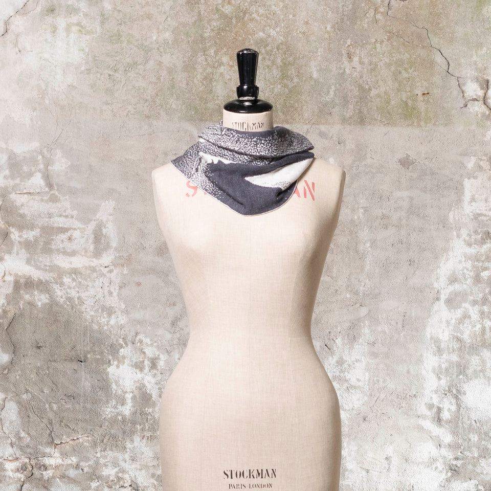 Knitted Byre cowl. Abstract, graphic design in an asymmetric shape. Shown in Charcoal and stone white