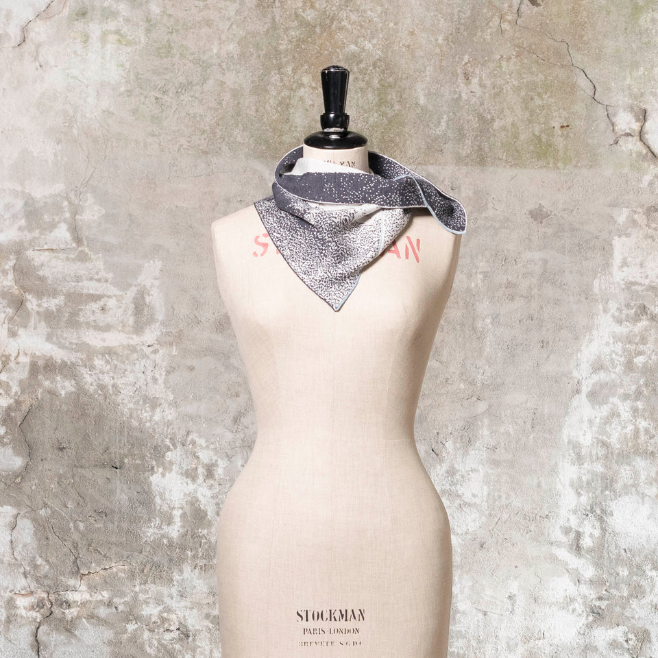 Knitted Byre cowl. Abstract, graphic design in an asymmetric shape. Shown in Charcoal and stone white