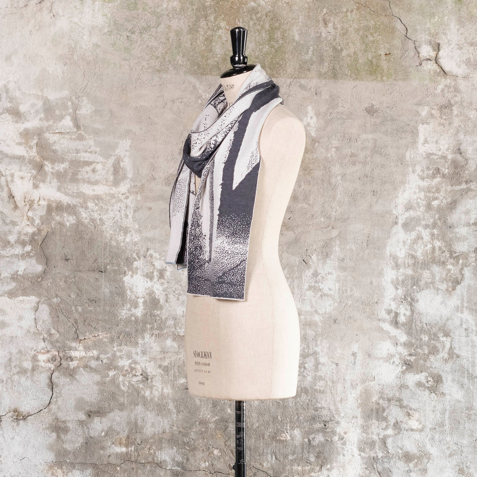 Knitted Byre scarf. Abstract, graphic design in an asymmetric shape. Shown in Charcoal and stone white