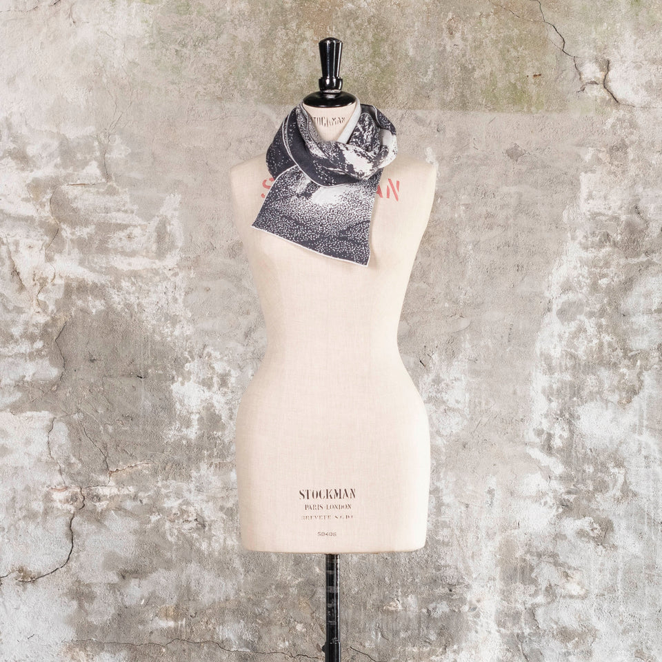 Knitted Byre scarf. Abstract, graphic design in an asymmetric shape. Shown in Charcoal and stone white