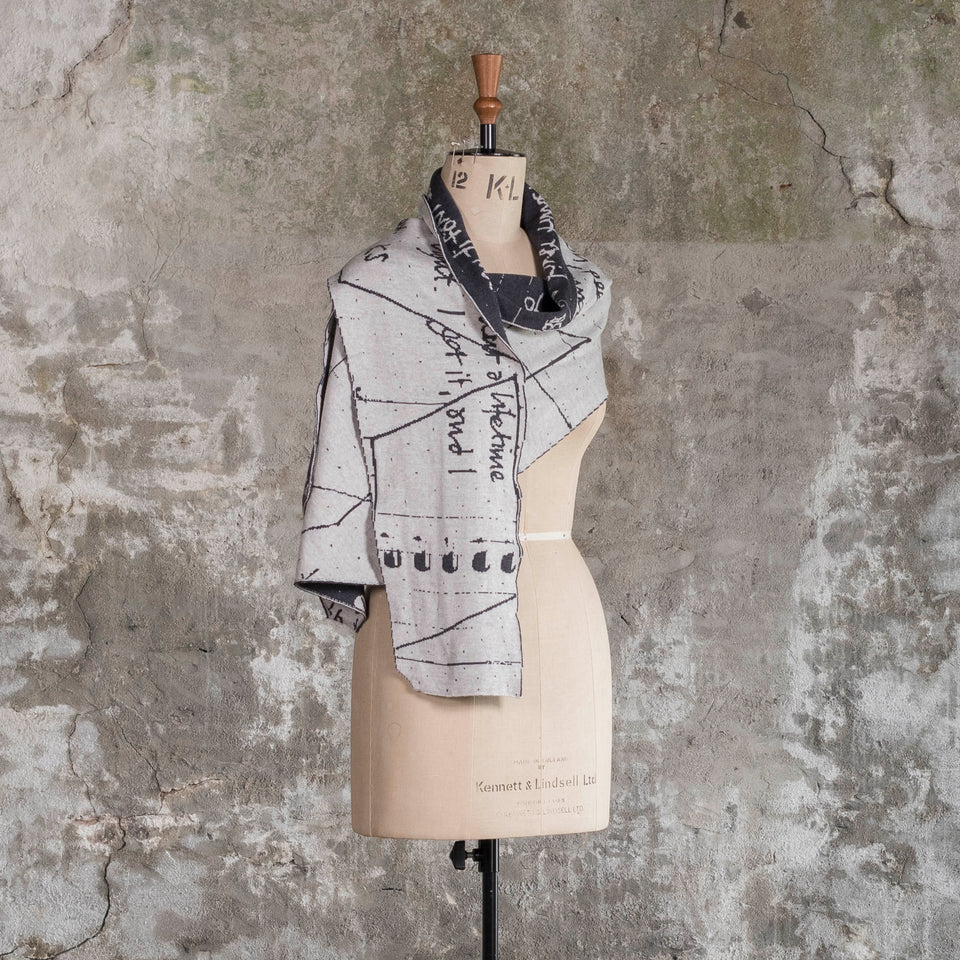 Knitted Byre cravat. Abstract, reversible graphic design in an asymmetric shape. Shown in Charcoal and stone white