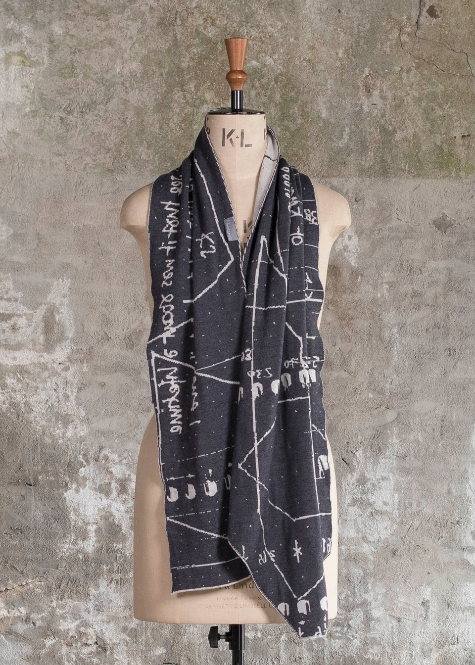 Knitted Byre cravat. Abstract, graphic design in an asymmetric shape. Shown in Charcoal and stone white