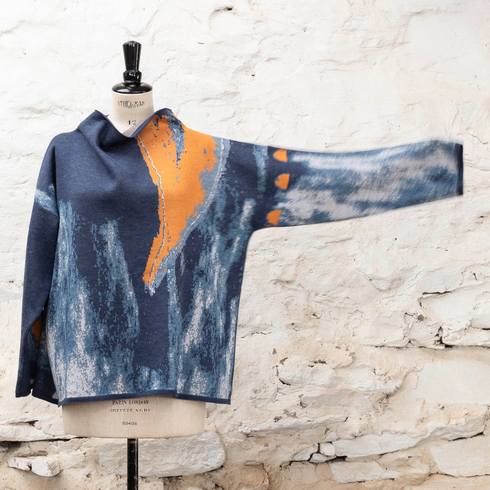 Modern Scottish statement knitwear. Wearable art, this jumper features a motif derived from drawings in Hoswick. Abstract textures in sea blues with orange highlights