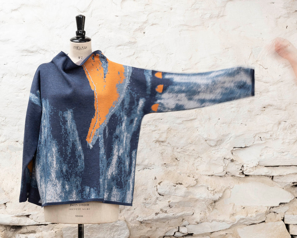 Modern Scottish statement knitwear. Wearable art, this jumper features a motif derived from drawings in Hoswick. Abstract textures in sea blues with orange highlights