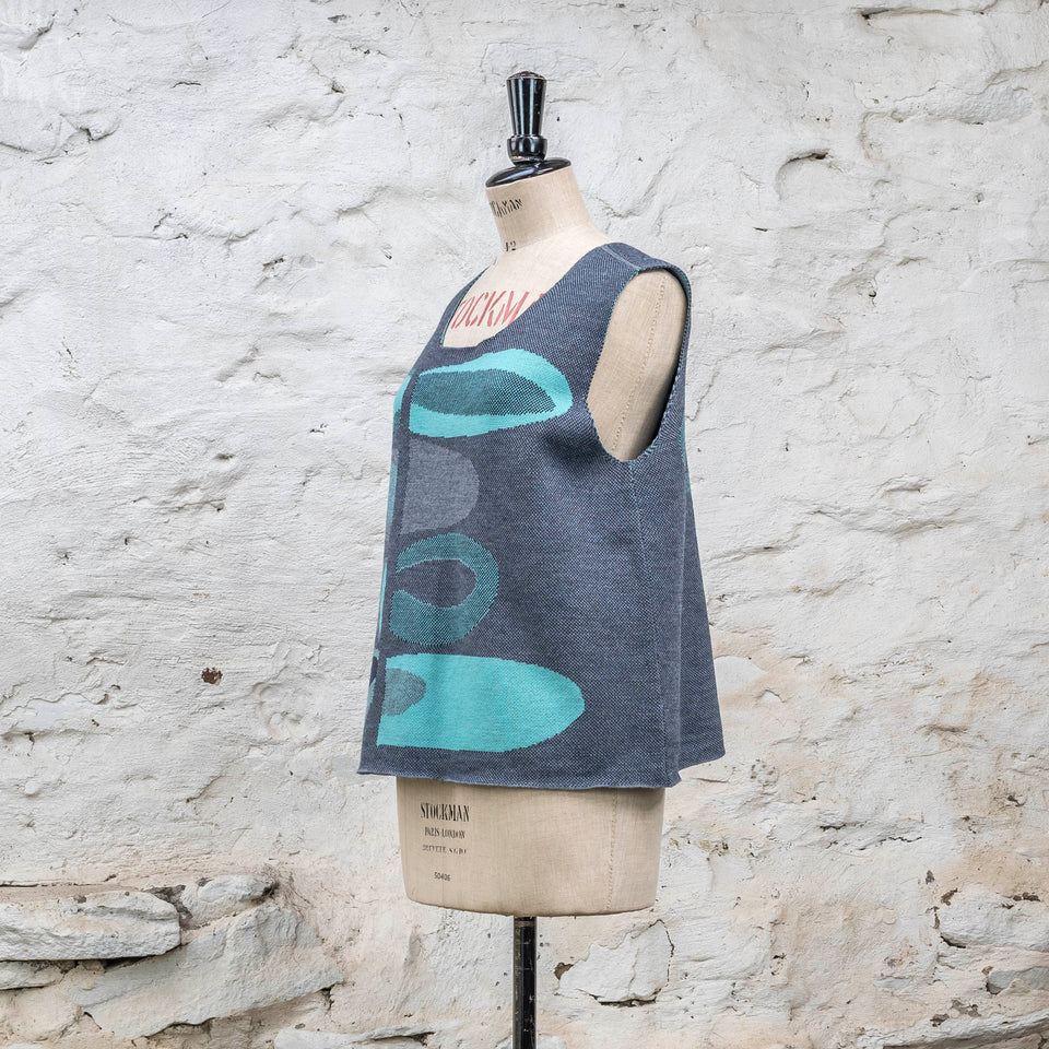 Knitted sleevless tanque in blues with accents in aqua. The pattern is abstract