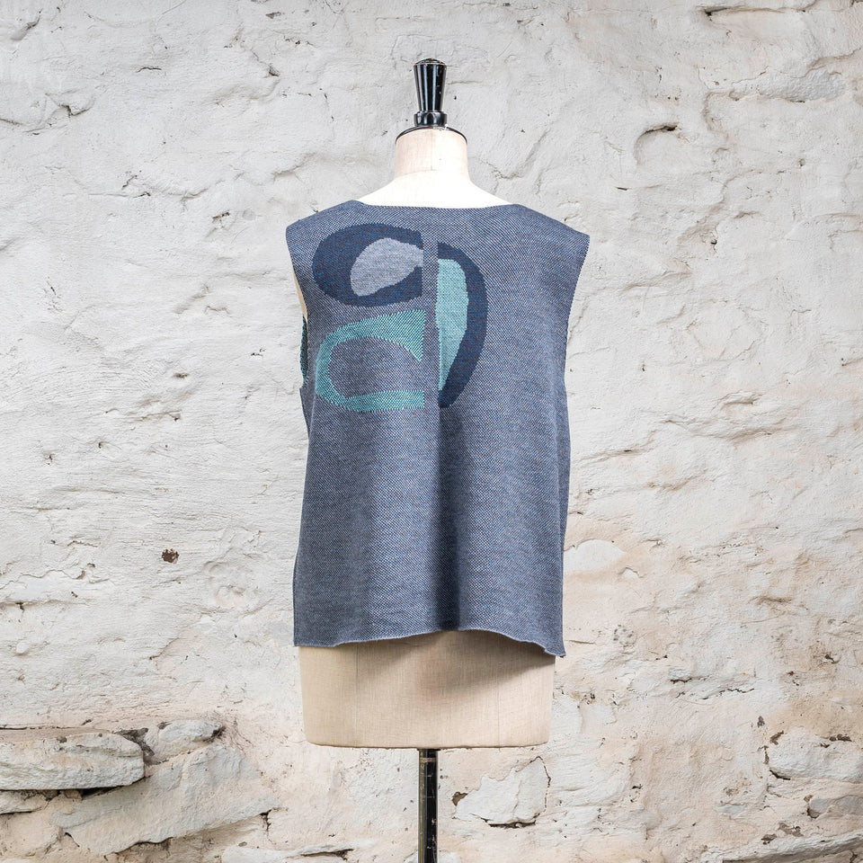 Knitted sleevless tanque in blues with accents in aqua. The pattern is abstract