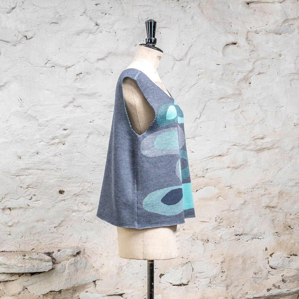 Knitted sleevless tanque in blues with accents in aqua. The pattern is abstract