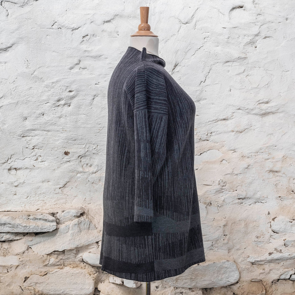 knitted inklines tunic, a straight cut longline jumper with stand-up neck. Linear, abstract design. Here shown in colourway midnight greys