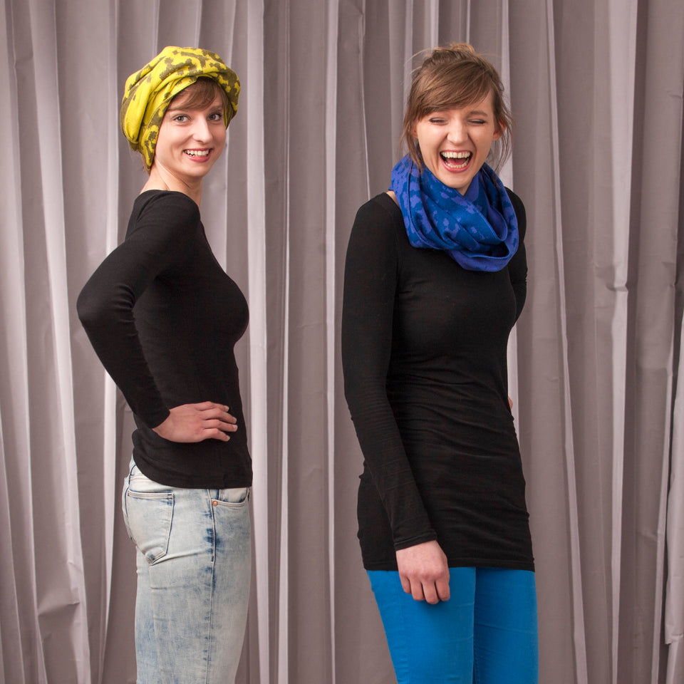 marlet twist scarf. mottled abstract animal print pattern, two shown in yellows and blues