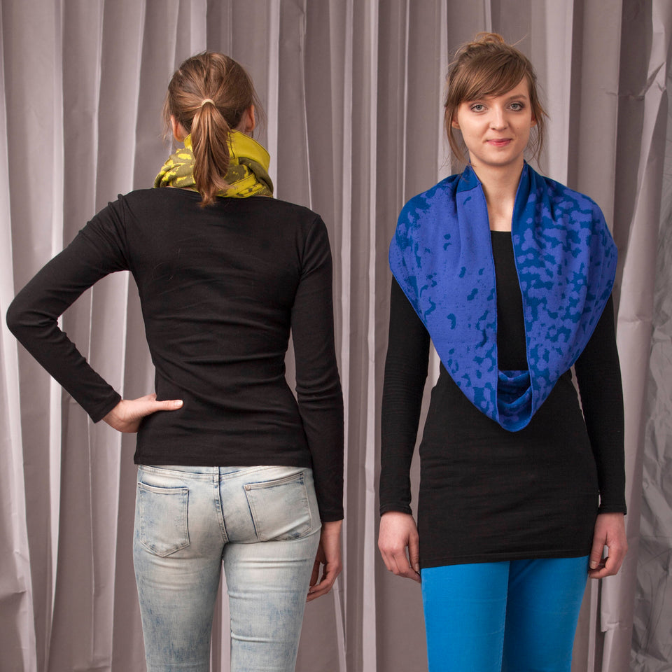 marlet twist scarf. mottled abstract animal print pattern, two shown in yellows and blues