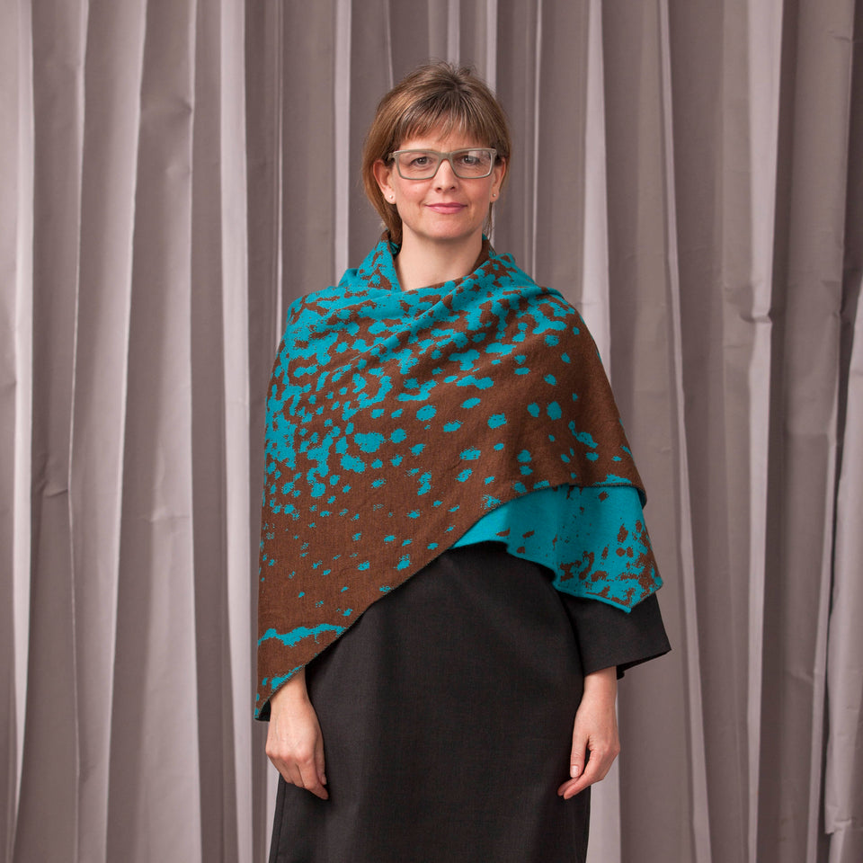 Knitted marlet wrap. Mottled animal print design show in in aqua and bronze