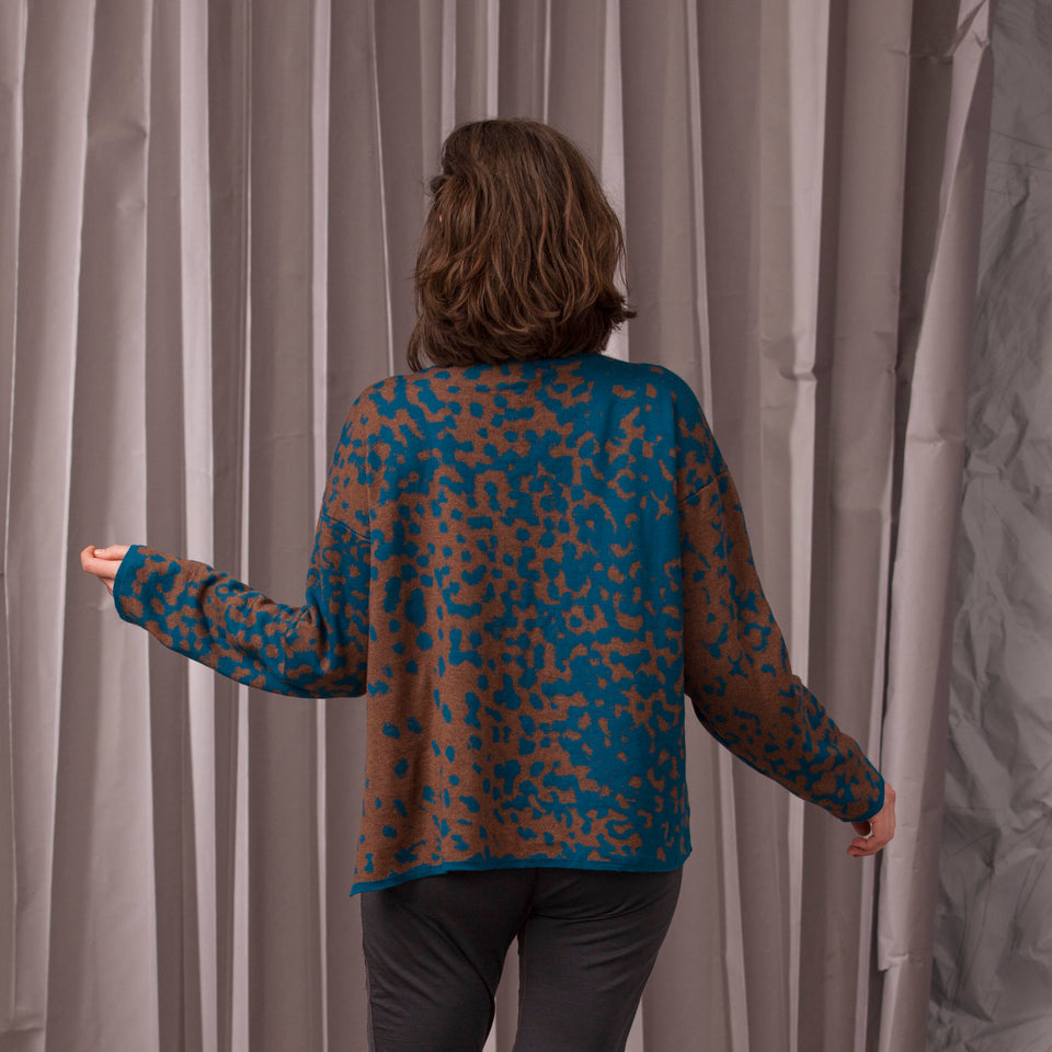 Marlet asymmetric knitted jacket. Mottled animal print, shown in dark teal and chestnut