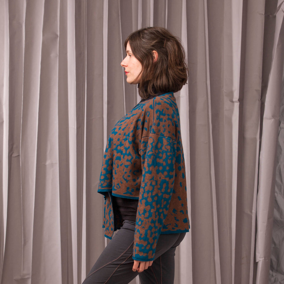 Marlet asymmetric knitted jacket. Mottled animal print, shown in dark teal and chestnut