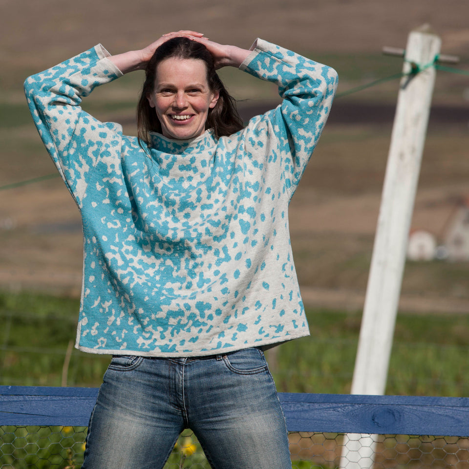 Knitted marlet jumper. Mottled animal print abstract pattern shown in turquoise and white