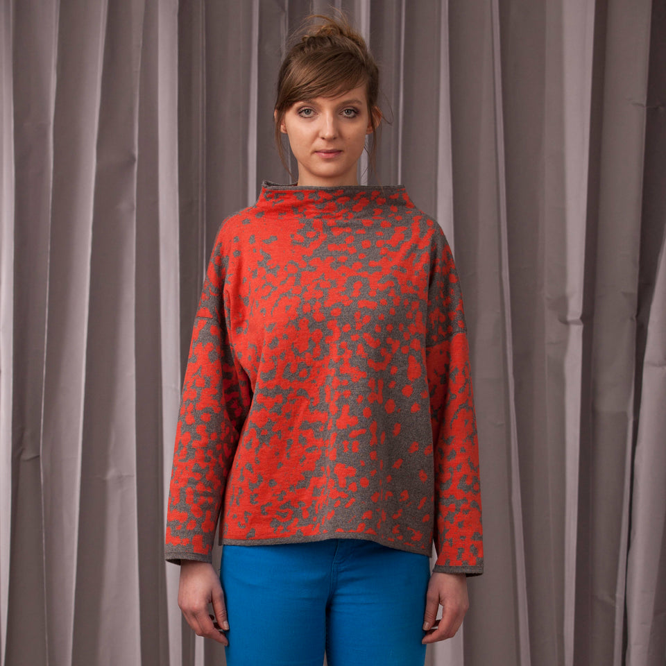 Knitted marlet jumper. Mottled animal print abstract pattern shown in coral and mid grey