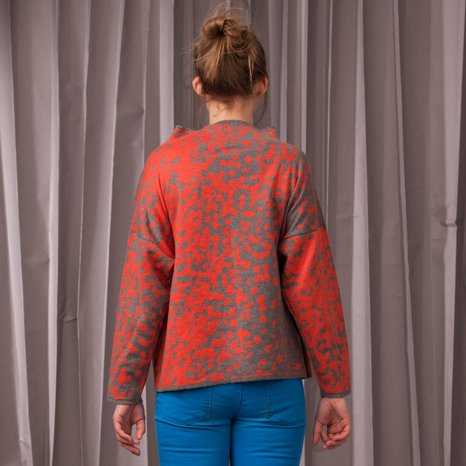 Knitted marlet jumper. Mottled animal print abstract pattern shown in coral and mid grey