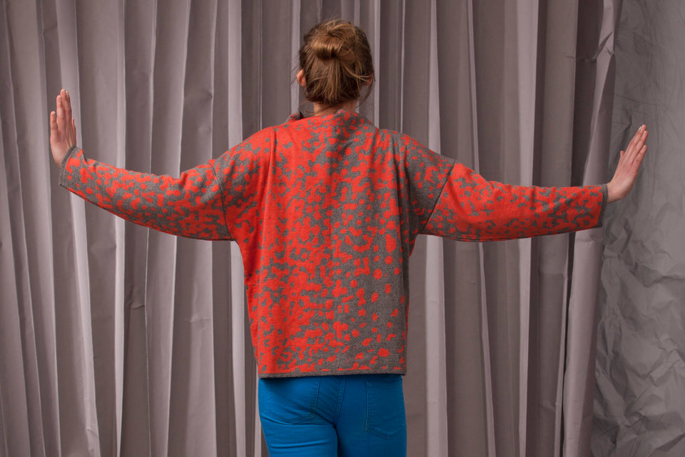 Knitted marlet jumper. Mottled animal print abstract pattern shown in coral and mid grey