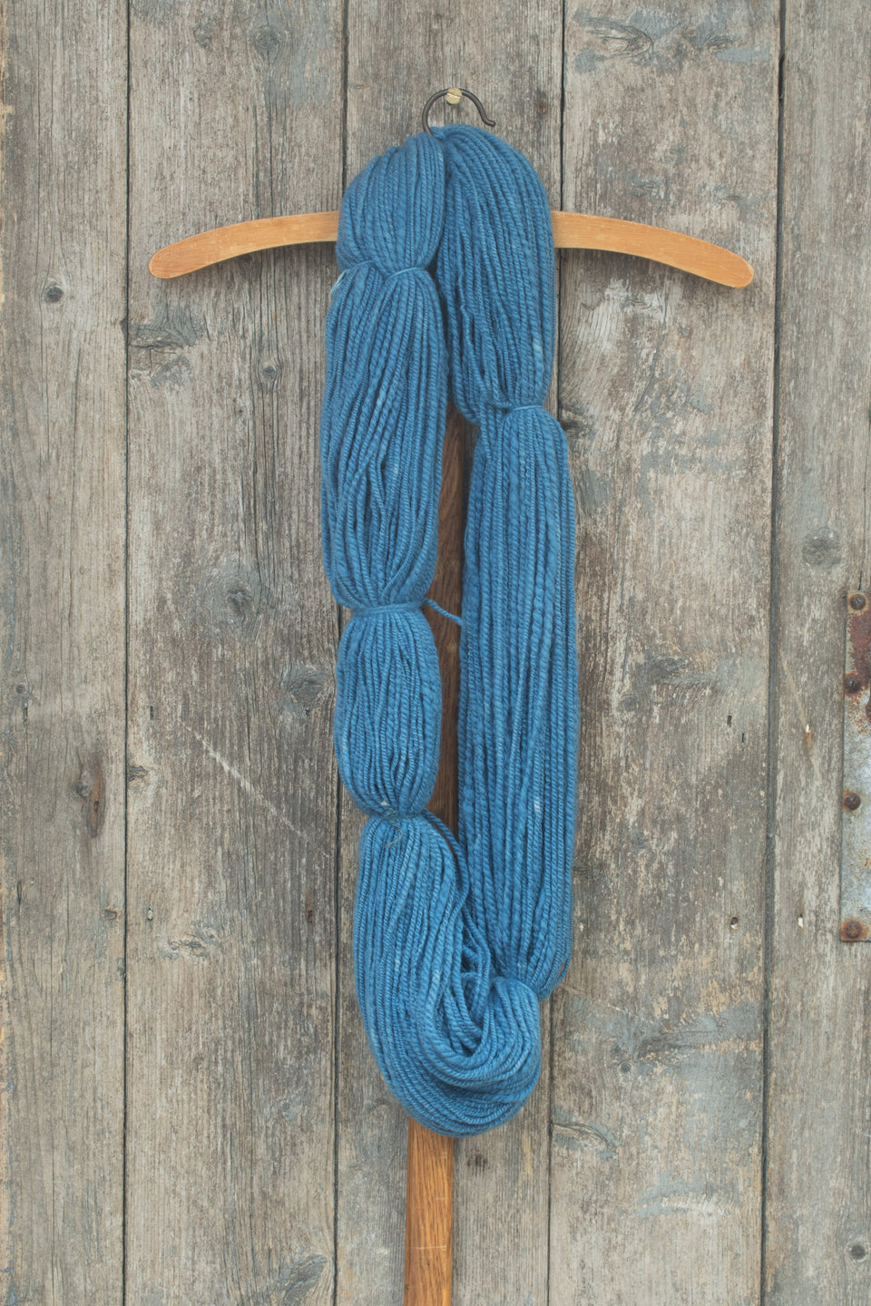 handspun, hand-dyed indigo yarn. polwarth and shetland blend. shown in a large hank