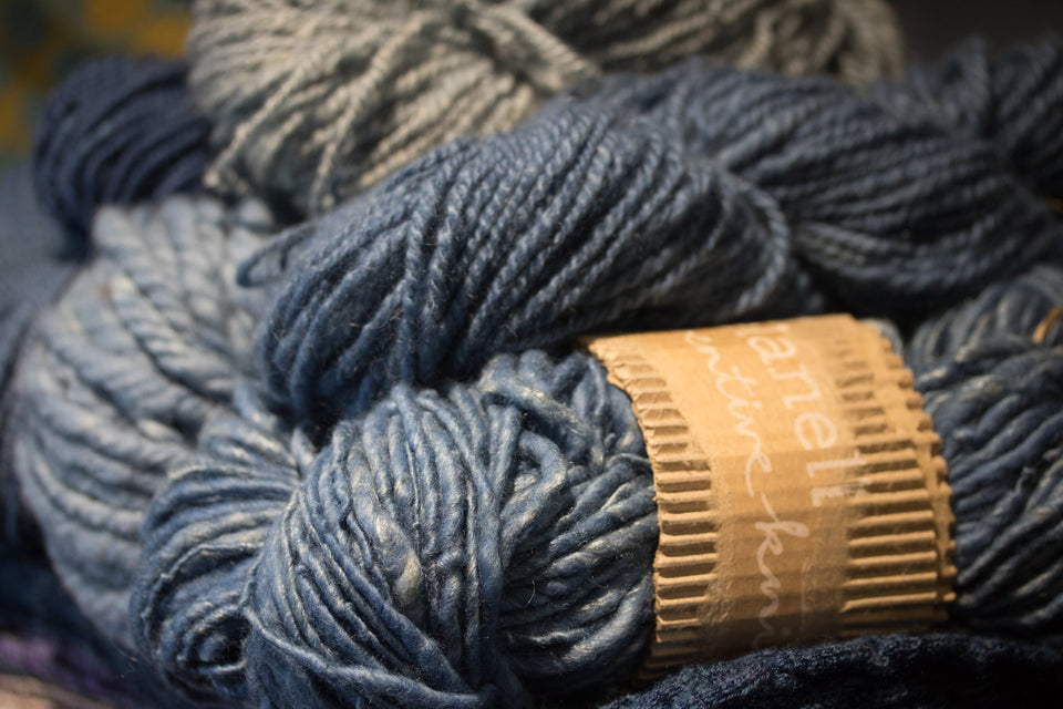 collection of handspun yarns dyed with natural indigo. shown with yarn bands