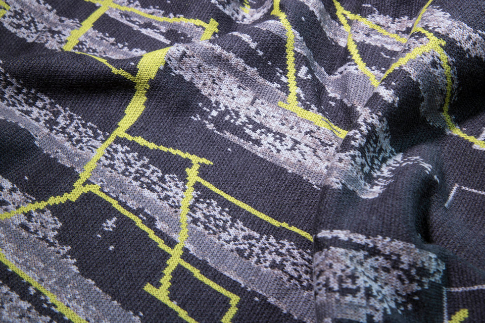 closeup up finely knitted Hoswick Paint cape - greys with linear limey yellow highlight design