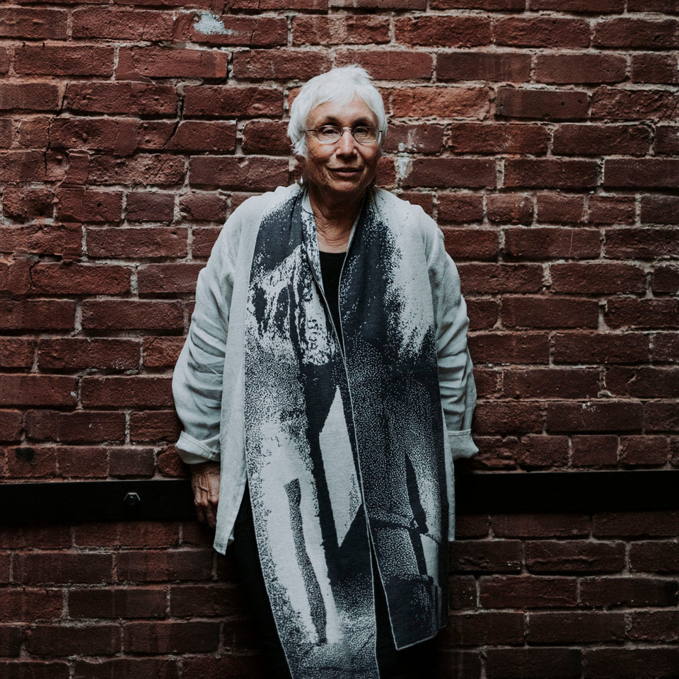 Knitted Byre scarf. Abstract, graphic design in an asymmetric shape. Shown in Charcoal and stone white