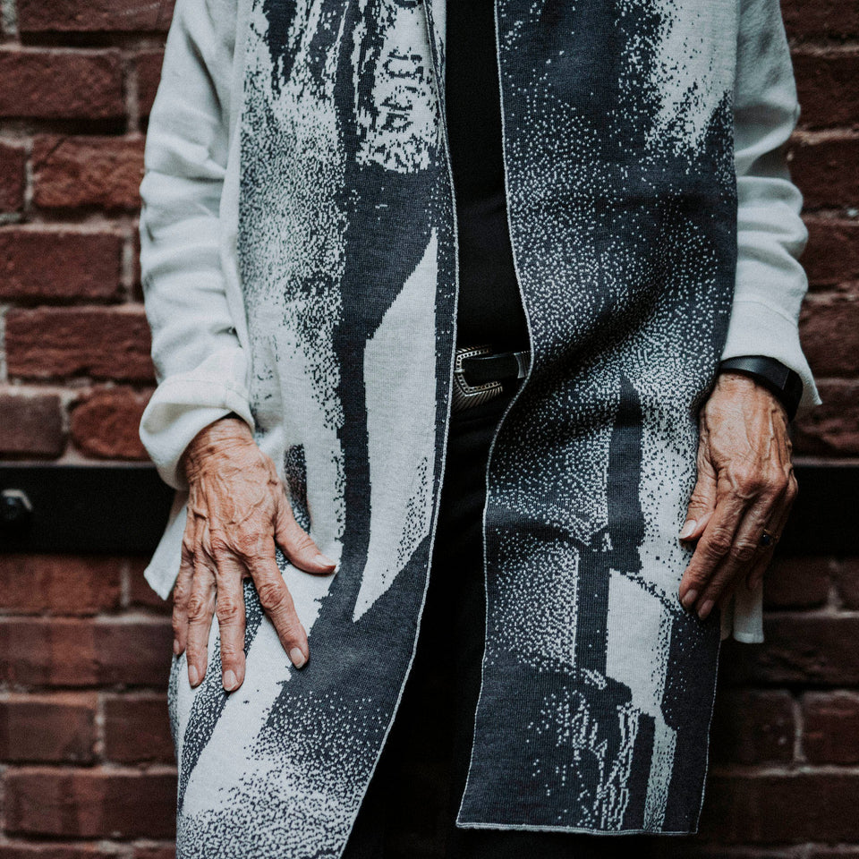 Knitted Byre scarf. Abstract, graphic design in an asymmetric shape. Shown in Charcoal and stone white