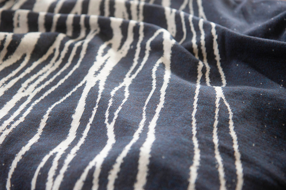 Swatch of the shoormal shetland cape with linear pattern in reverse - this time picked out in white on smoky midnight blue. The blue is actually a marl made up of mocha and blue yarn.