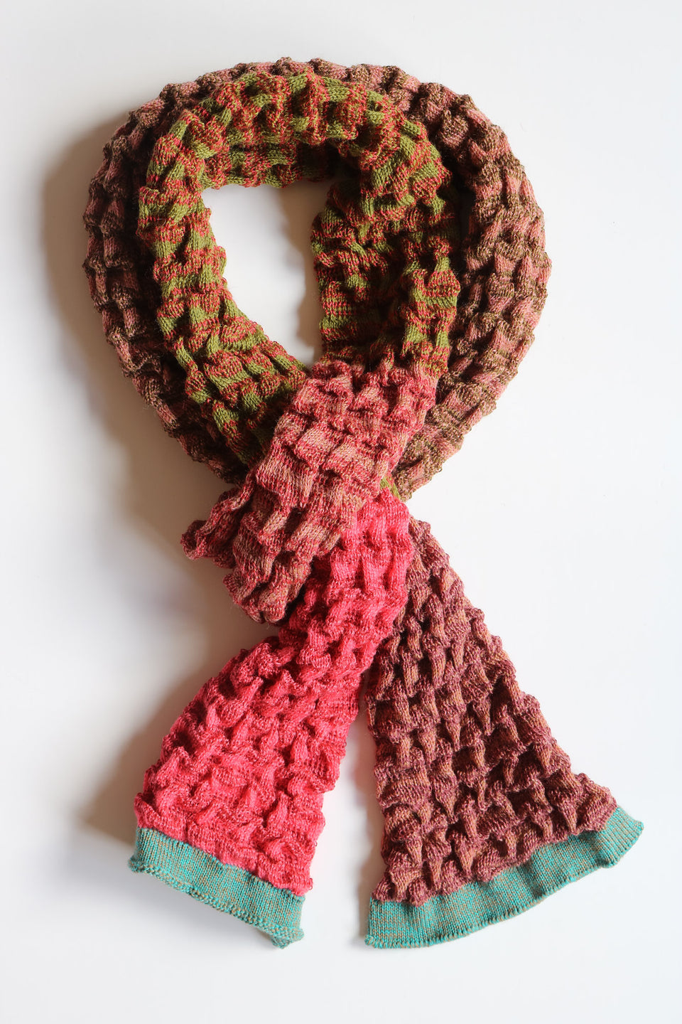 Rigg scarf. Ridged textile in stripes and colour blocks. Show in rose aqua gold mix
