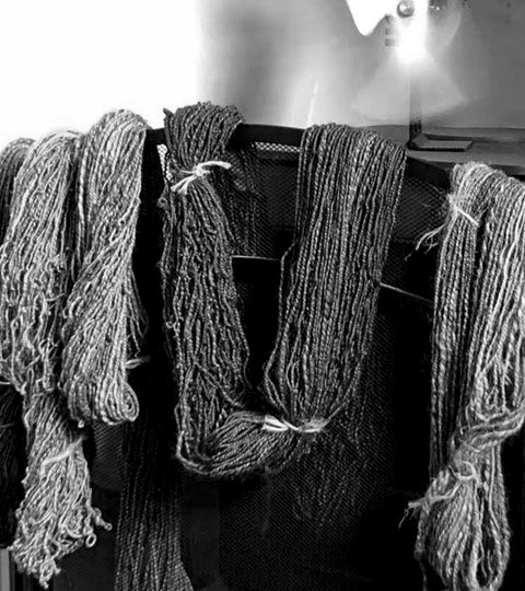 Skeins of handspun yarn drying in front of a stove