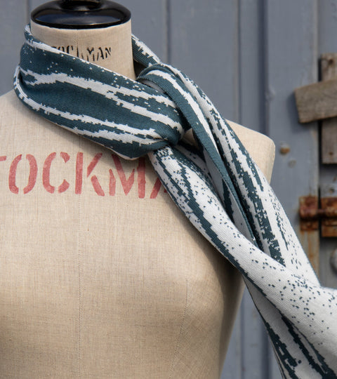 Shoormal scarf with a pattern related to the  Shetland seashore in shaela blue, an airforce type blue, and moonlit sand - a pearly off-white.
