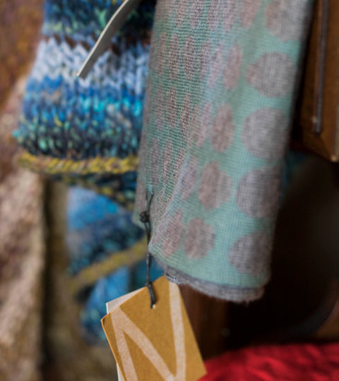Detail of knitwear in the Nielanell studio, Hoswick, Shetland. A scarf if a pebble design, in sea greens and grey.