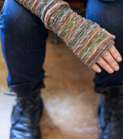 A rigg gauntlet shown being work on one arm. Also visible, models legs wearing indigo jeans and black lace up boots
