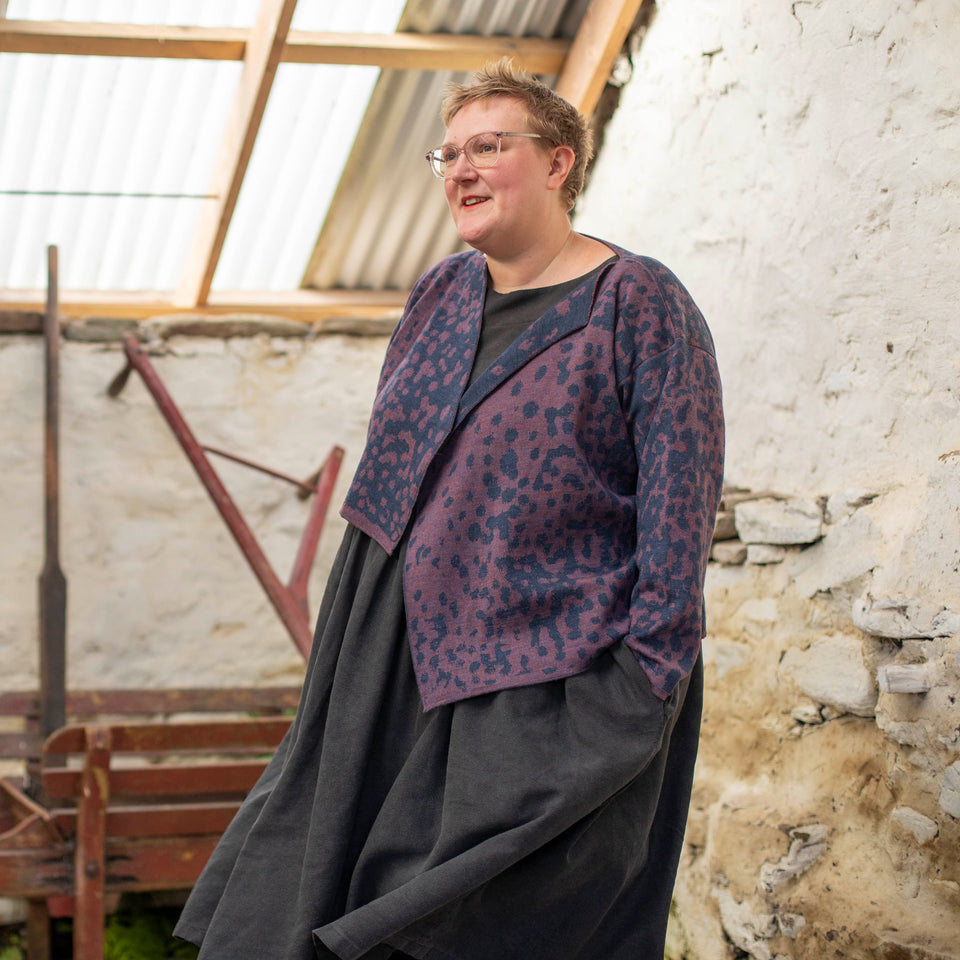 modern scottish knitwear, a biker jacket cardigan in animal print - blue and purple.