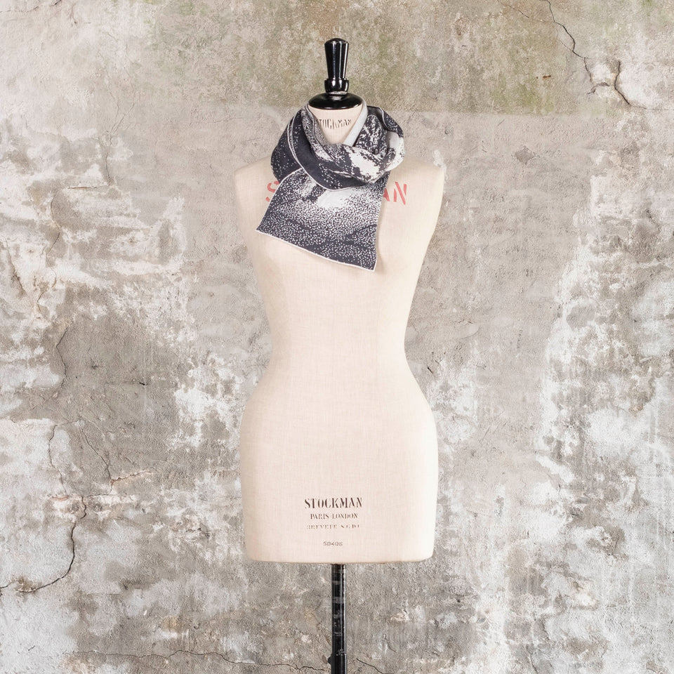 Knitted Byre scarf. Abstract, graphic design in an asymmetric shape. Shown in Charcoal and stone white