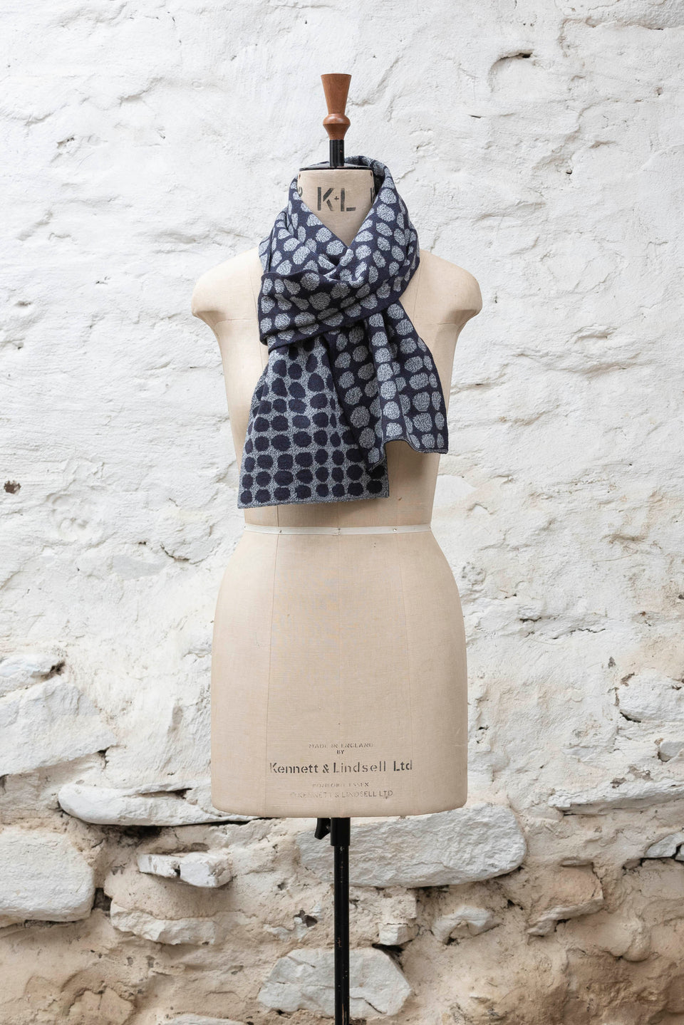 Knitted scarf with an irregular dot design in two colours. Show in blue black and marl