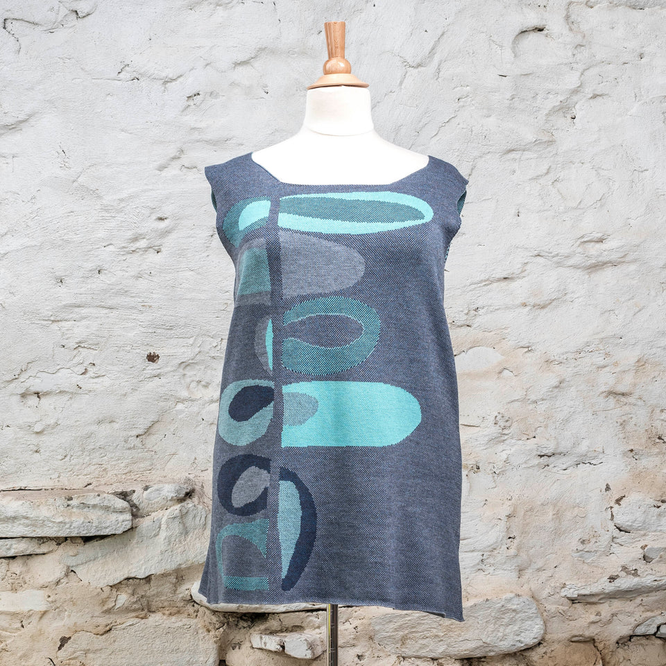 Knitted sleevless tanque in blues with accents in aqua. The pattern is abstract
