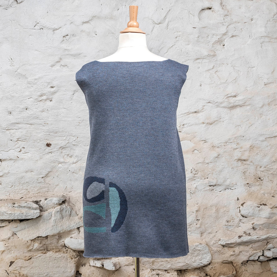 Knitted sleevless tanque in blues with accents in aqua. The pattern is abstract