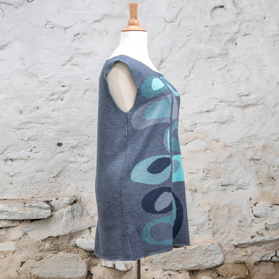 Knitted sleevless tanque in blues with accents in aqua. The pattern is abstract