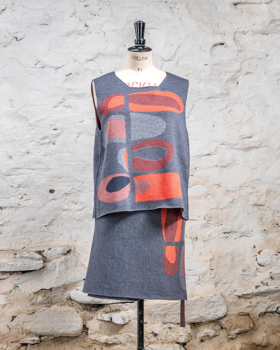 Knitted wrap skirt in blues with accents in coral. The pattern is abstract. Shown with tanque in same pattern.