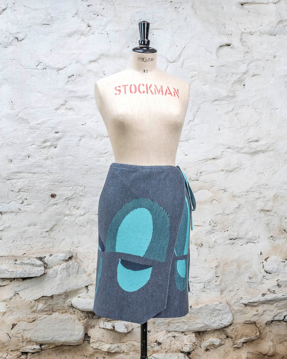 Knitted wrap skirt in blues with accents in aqua. The pattern is abstract
