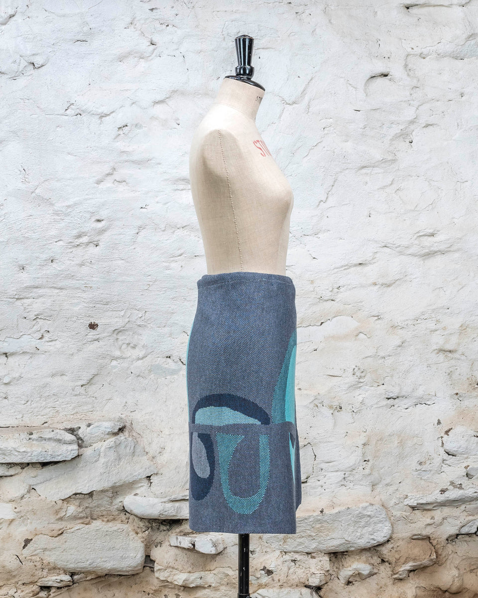 Knitted wrap skirt in blues with accents in aqua. The pattern is abstract