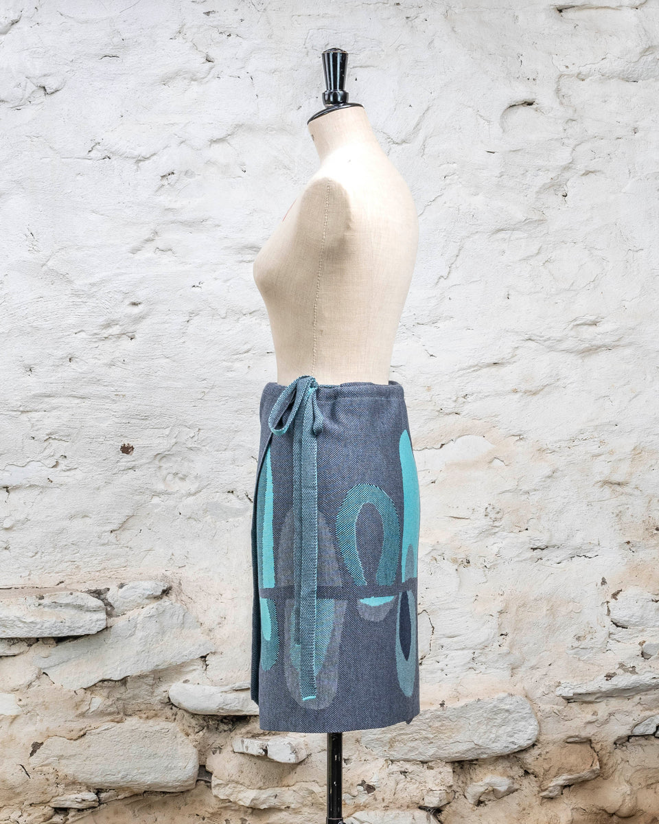 Knitted wrap skirt in blues with accents in aqua. The pattern is abstract