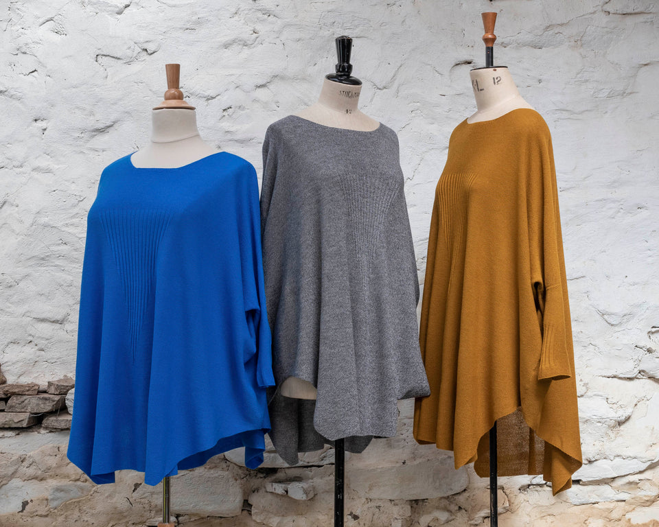 Knitted Saand jumper, shown in three colours. Boxy but flowing shape. Flat colour in a textured stitch. Shown in bright blue, grey and bronze
