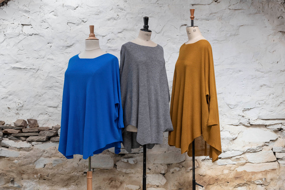 Knitted Saand jumper, shown in three colours. Boxy but flowing shape. Flat colour in a textured stitch. Shown in bright blue, grey and bronze
