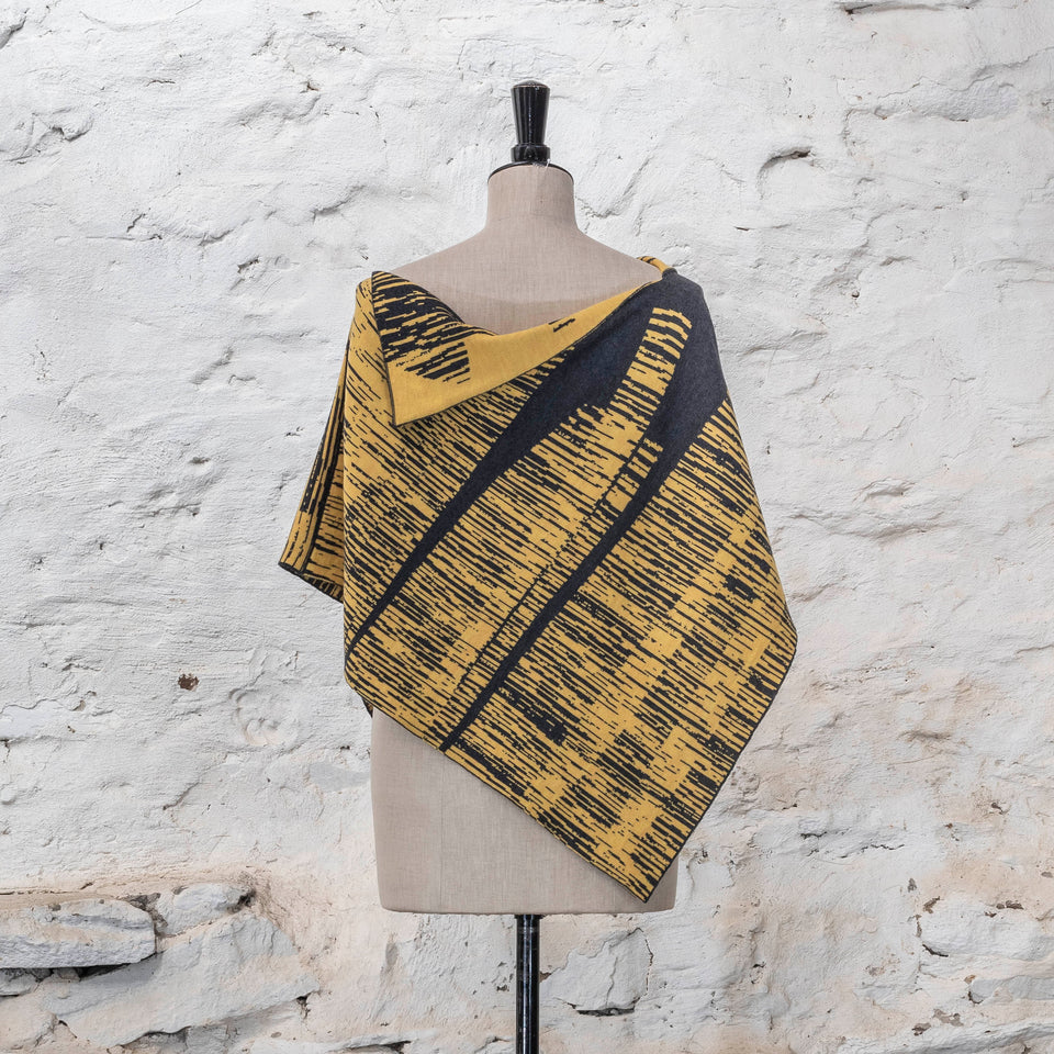 knitted inklines cape. graphic, linear, abstract pattern. Show in yellow with dark grey colourway
